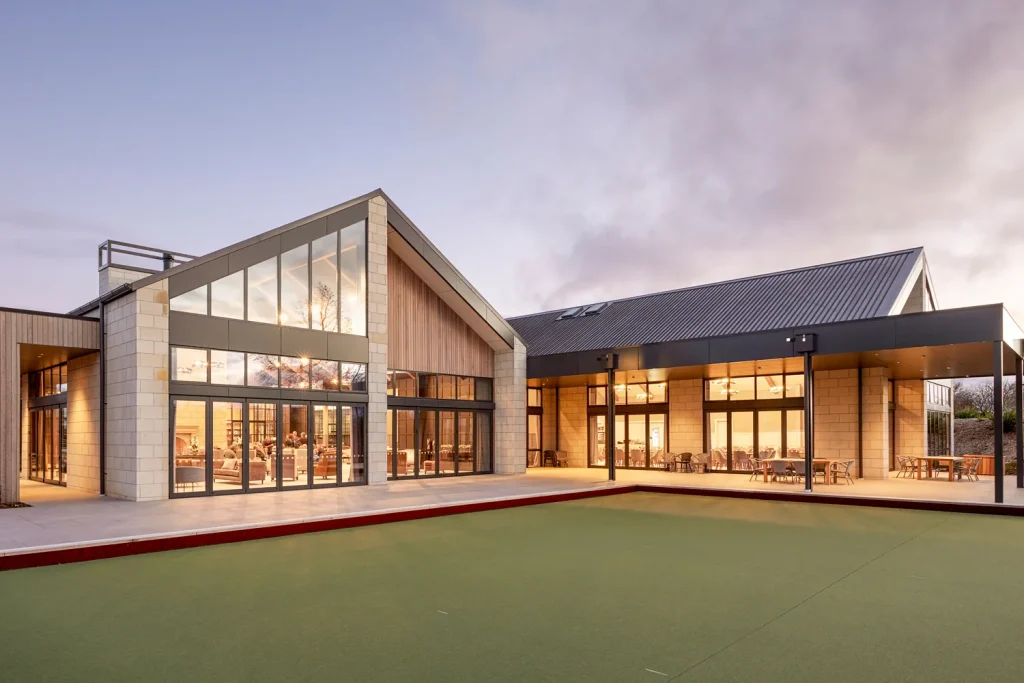 The back of the Clubhouse and bowling green at sunset at Tamahere Country Club