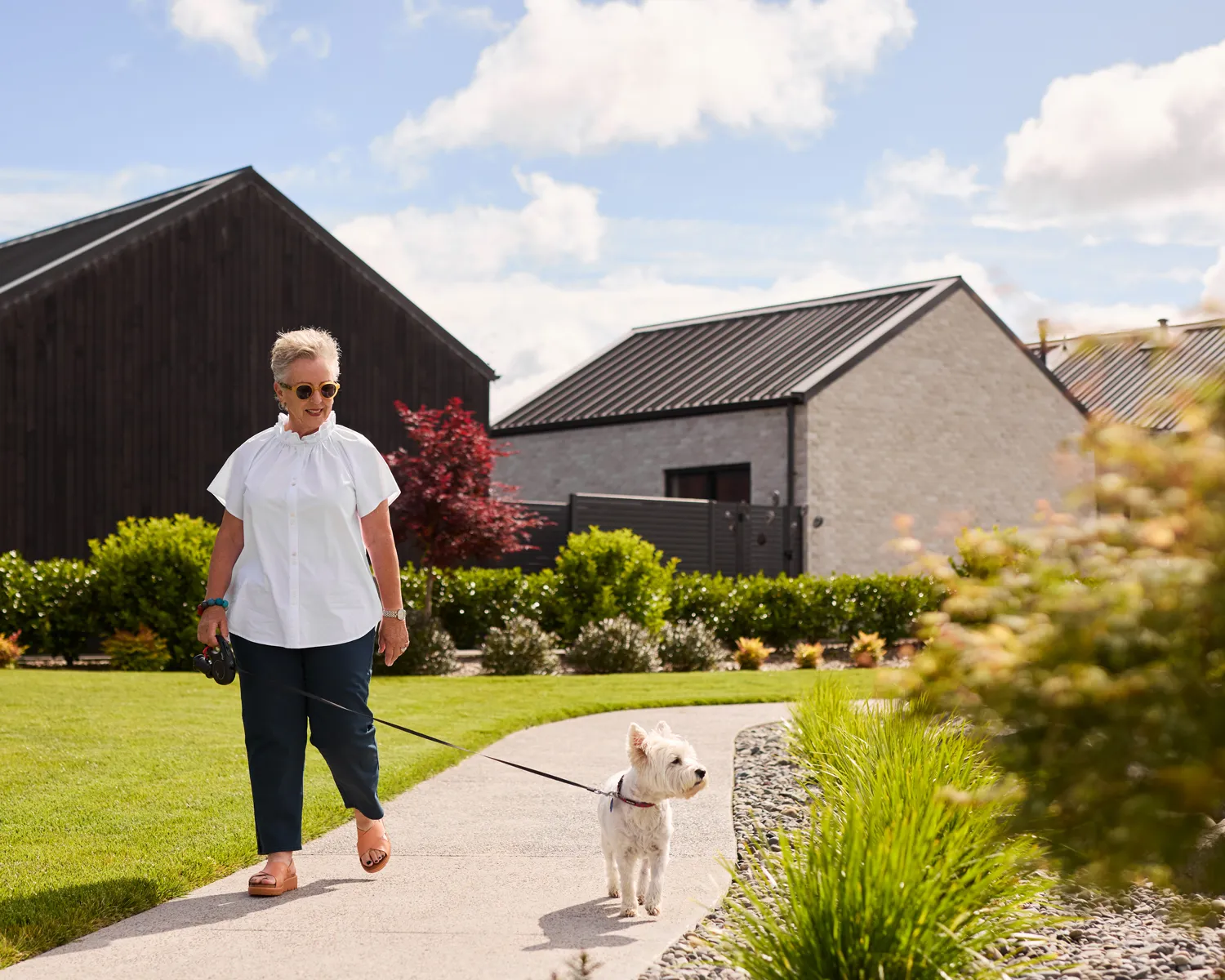 Tamahere Country Club resident walking her dog around the village.