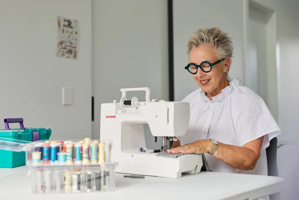 Female resident sewing in the Hobby Centre at Tamahere Country Club