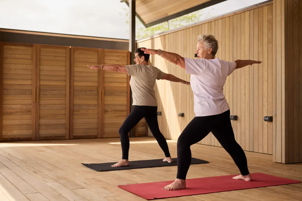 Residents stretching and doing yoga at the Lakehouse Pavilion in Tamahere Country Club