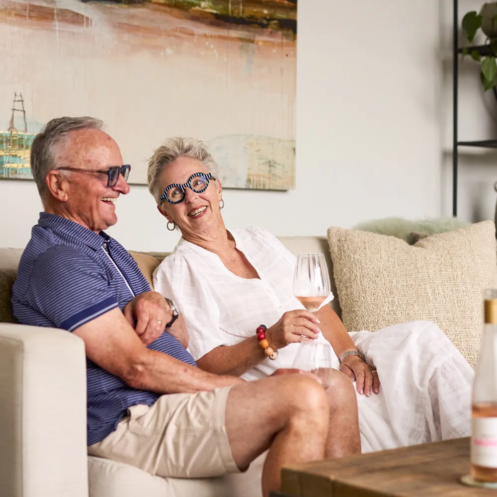 Resident couple drinking rose wine in retirement villa at Tamahere Country Club