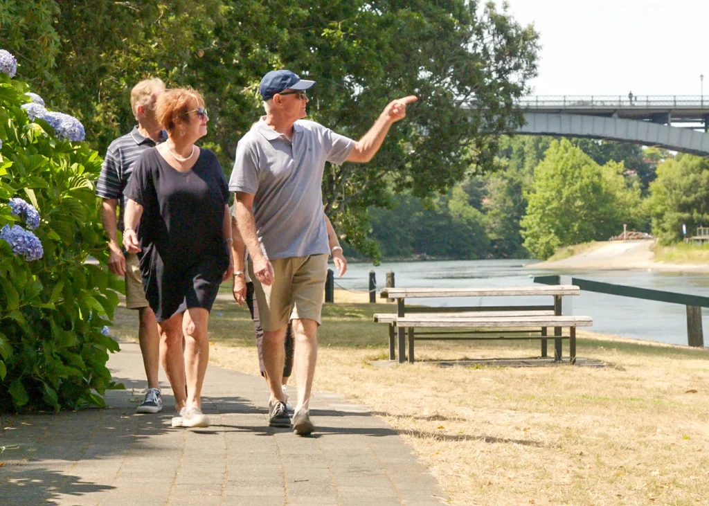 Residents enjoying a walk by the Waikato River.